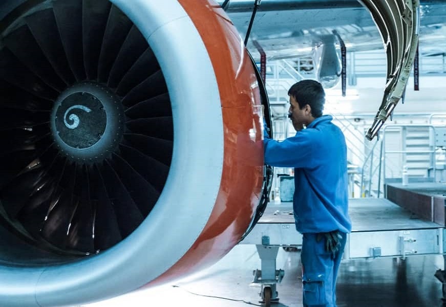 man-stands-orange-turbine-engine_1-1